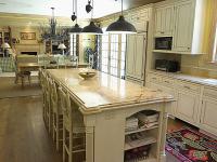 Farmhouse style kitchen with offwhite cabinets and dark accessories