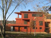 back exterior of red urban villa - Ballard & Mensua