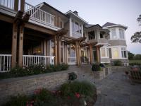 Carr project - nautical New England waterfront home - rear patio at sunset
