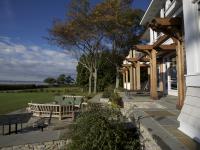 Carr project - nautical New England waterfront home - side patio view in rear