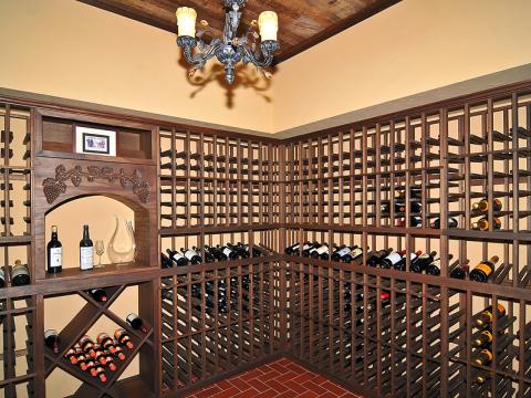 Expansive, dark stained wood wine cellar for Sugarland Lane