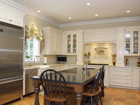 Bright and white farmhouse style kitchen with stainless steel appliances
