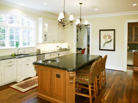 Left angle of Selkirk Drive's new kitchen with kitchen island and pendant lighting