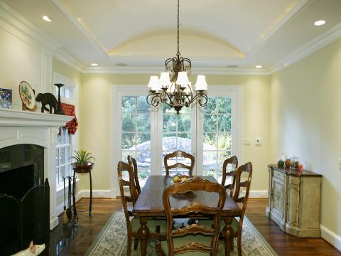 Informal dining room with french doors and dark green accents