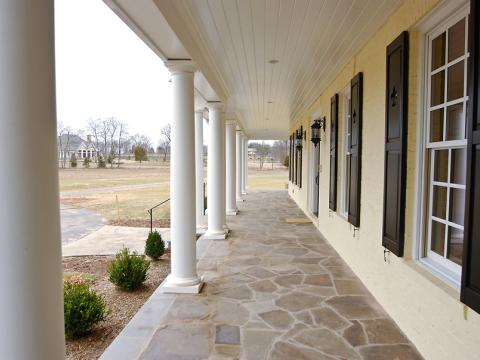 An expansive front porch on Sugarland Lane by Frank M Bell