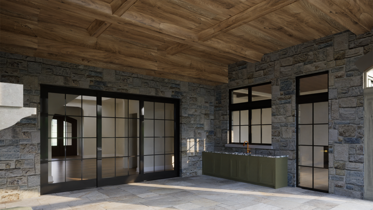 Outdoor living space designed by Ballard+Mensua Architecture, featuring natural stone walls, wide-plank wood ceiling, slate flooring, and black-framed sliding glass doors. A built-in green cabinetry sink area adds functionality, while the open-air design blends rustic textures with refined detailing, ideal for transitional indoor-outdoor entertaining.