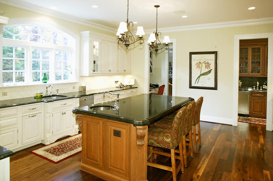 Left angle of Selkirk Drive's new kitchen with kitchen island and pendant lighting