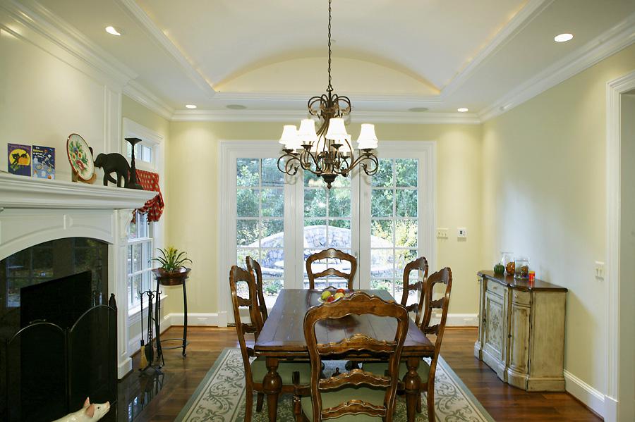 Informal dining room with french doors and dark green accents
