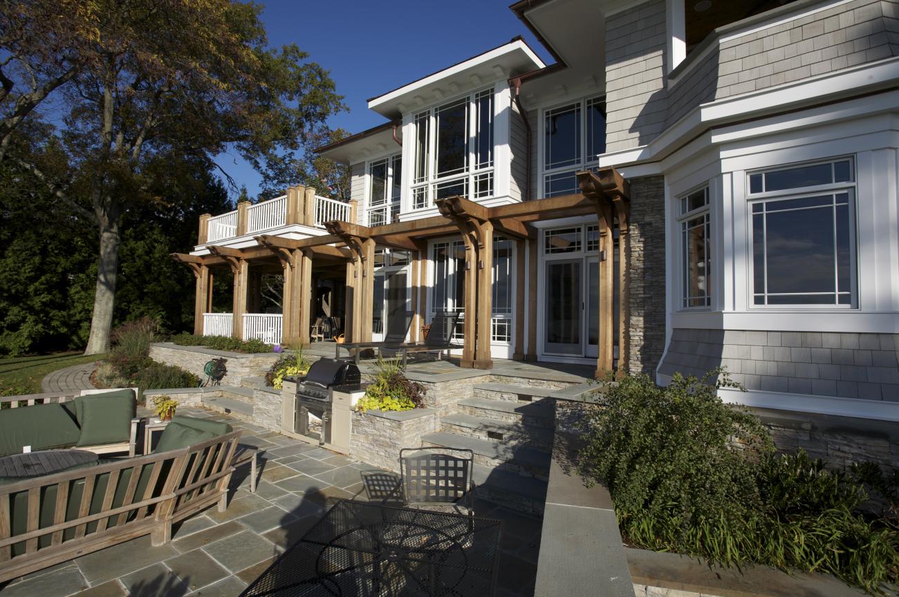 Carr project - nautical New England waterfront home - rear patio in sunlight